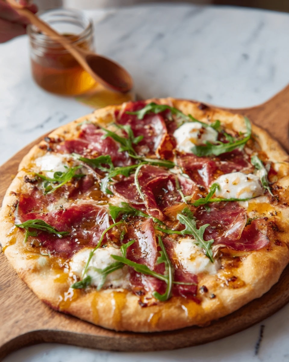A round pizza with a golden-brown crust sits on a wooden board, topped with thin slices of reddish-brown cured meat evenly spread across the surface. There are several white dollops of creamy cheese melting among the meat, and fresh green arugula leaves scattered on top, adding a pop of color. The pizza looks slightly glossy with a drizzle of honey in a glass jar nearby, and a woman's hand holding a wooden spoon is blurred in the background. The setting has a white marbled texture surface beneath the board. photo taken with an iphone --ar 4:5 --v 7
