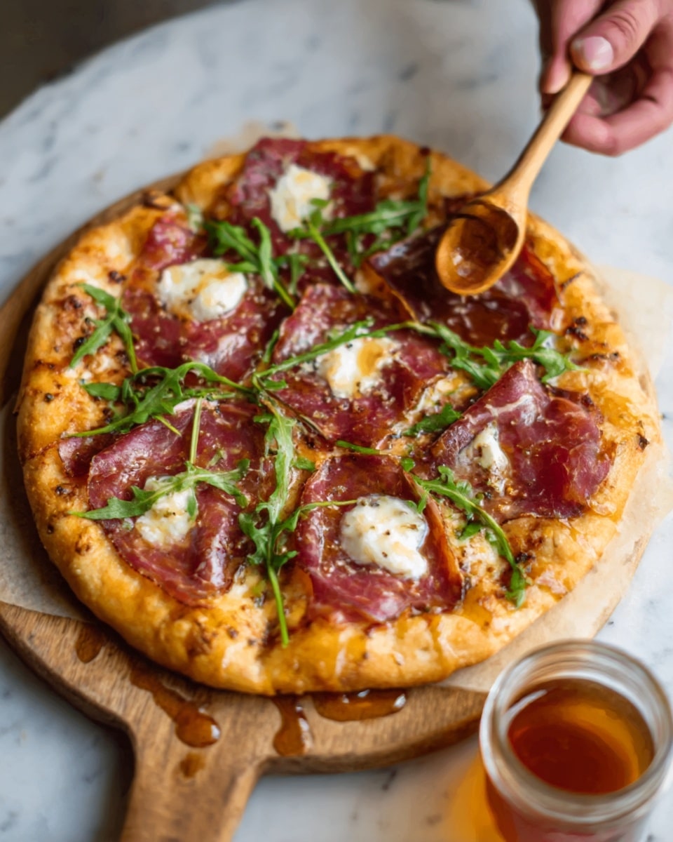 A round pizza with a golden-brown crust rests on a wooden board placed over a white marbled surface. The pizza has one visible layer of melted cheese with an uneven texture, topped with thin slices of reddish-brown prosciutto arranged in a scattered pattern. Bright green fresh arugula leaves are spread on top, adding contrast in color. The cheese appears creamy white with some melted edges. A woman's hand holding a small wooden utensil is visible in the upper left corner, hovering over a bowl of dark reddish sauce. Photo taken with an iphone --ar 4:5 --v 7