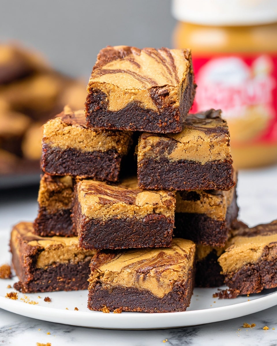 A stack of seven square brownie pieces sits on a white plate, each piece showing two clear layers: a thick, dark brown chocolate base with a moist texture and a swirled top layer of creamy tan peanut butter with a slightly cracked surface. The peanut butter swirls create a marbled effect blending into the chocolate underneath. The brownies are slightly crumbly around the edges, with some crumbs scattered on the white marbled surface beneath the plate. In the background, the blurred image of a peanut butter jar adds context to the flavor. photo taken with an iphone --ar 4:5 --v 7