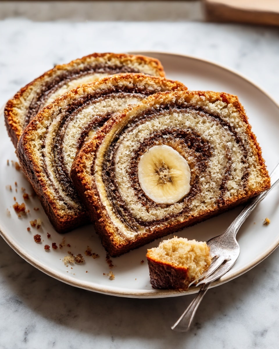 Three slices of banana swirl bread are placed side by side on a white plate. Each slice has multiple layers of light brown cake and darker brown cinnamon swirl, with a visible round slice of banana embedded in the center. The bread has a soft, crumbly texture with small bits of crumbs scattered on the plate around it. A small piece of bread is held on the tines of a silver fork resting on the right side of the plate. The whole setup is on a white marbled surface with soft, natural light coming from the back, highlighting the textures and colors. Photo taken with an iphone --ar 4:5 --v 7
