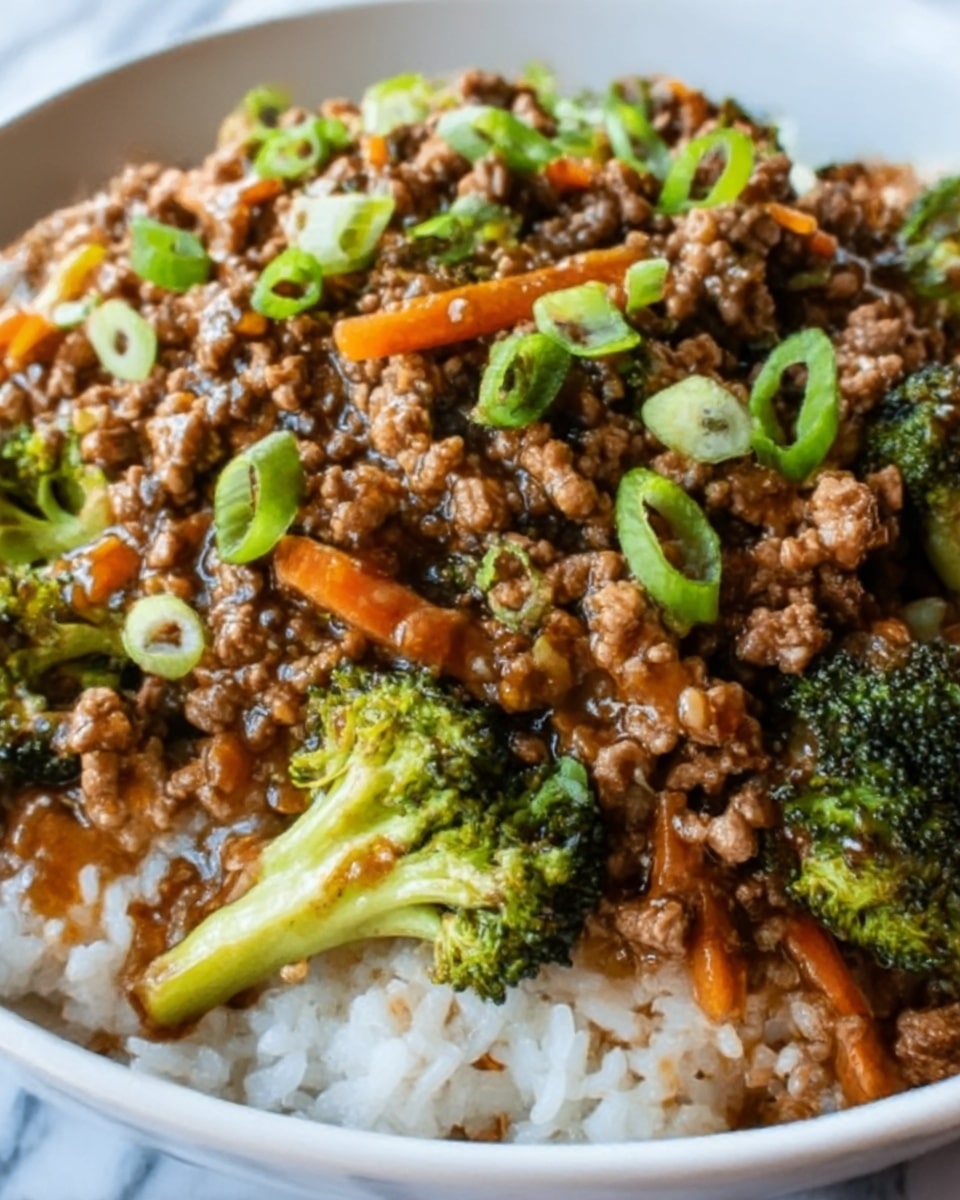 A close-up view of a white bowl filled with a dish featuring a base layer of fluffy white rice. On top of the rice is a thick layer of brown ground meat mixed with pieces of bright green broccoli and thin, orange carrot strips. The meat mixture is shiny with a glossy sauce that adds a rich texture. The dish is garnished with thin slices of fresh green onions scattered over the top. The bowl sits on a white marbled surface, and the photo taken with an iphone --ar 4:5 --v 7