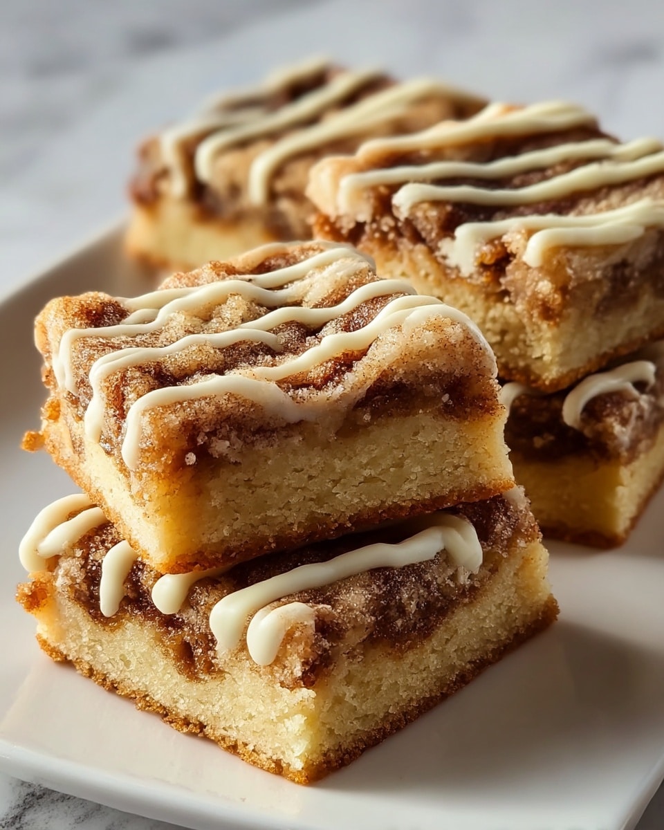 The image shows two cinnamon roll bliss bars stacked on top of each other on a white marbled surface. Each bar has three main visible layers: a soft, light golden-brown dough layer at the bottom and top, a thick, dark brown cinnamon sugar swirl in the middle, and a creamy, white icing layer spread over the top with some dripping down the sides. The texture of the dough looks moist and crumbly, while the cinnamon swirl appears dense and sugary. The icing has a smooth, glossy finish that contrasts with the rougher texture of the cinnamon filling. Photo taken with an iphone --ar 4:5 --v 7