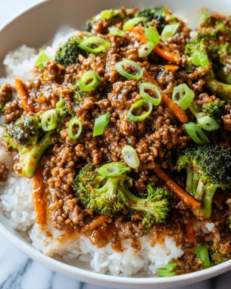 This image shows a dish with three main layers. At the bottom, there is a base of plain white rice with a soft texture. On top of the rice, there is a thick layer of ground meat cooked with small pieces of broccoli and thin carrot strips, all mixed in a dark brown sauce. The dish is garnished with chopped green onions, adding a fresh green color on top. The food is served in a white bowl, placed on a white marbled surface. Photo taken with an iphone --ar 4:5 --v 7