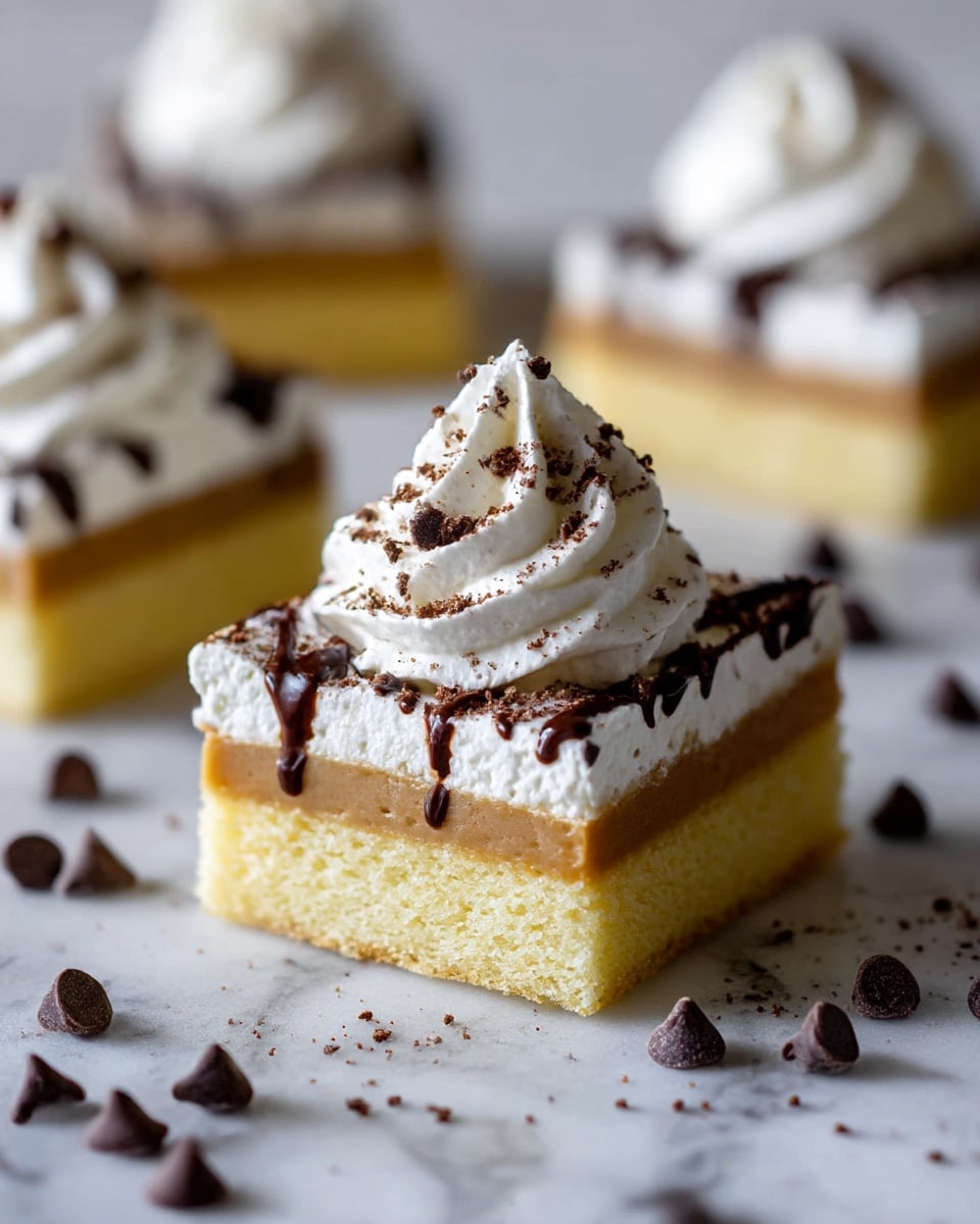 The image shows a close-up of a square, three-layer dessert bar placed on a white marbled surface. The bottom layer is a thick, fluffy, light yellow cake base. Above it is a light brown creamy layer, possibly caramel or butterscotch. The top layer is a thick spread of white whipped cream, crowned with a tall swirl of whipped cream dusted with fine chocolate powder. Drizzled dark chocolate syrup and scattered small chocolate chips and crumbs decorate the top and surrounding surface, adding texture and contrast. The focus is on one bar in the foreground with three more blurred in the background. photo taken with an iphone --ar 4:5 --v 7